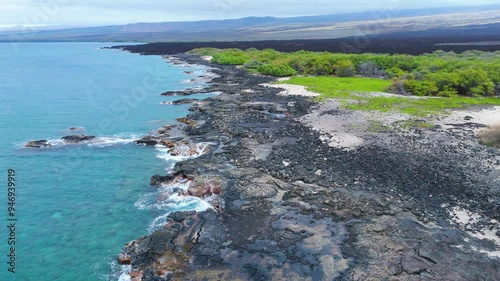 Aerial view of beautiful black sand beach and lava field with ocean waves, Kona, Hawaii Island, United States. photo