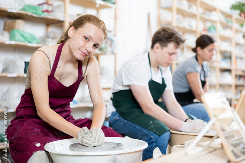 Girl teenager learns how to create pottery in the workshop photo