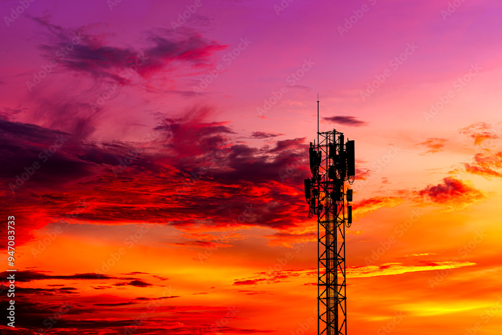 Telecommunication towers with colorful sky as a backdrop in the morning and sunlight reflecting off clouds create a stunning and mesmerizing light effect. Concept of innovation, technology and environ Telecommunication towers with colorful sky as a backdrop in the morning and sunlight reflecting off clouds create a stunning and mesmerizing light effect. Concept of innovation, technology and environ