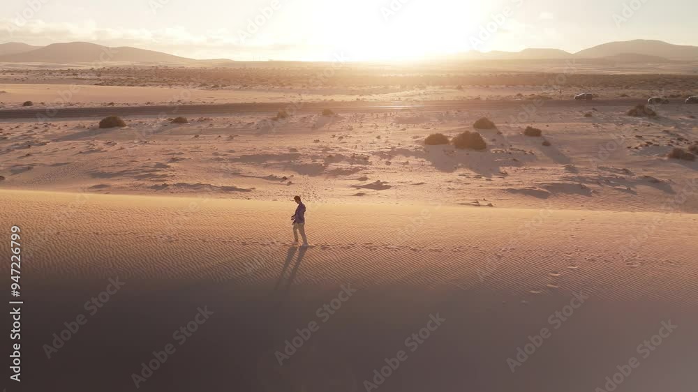 Aerial view of serene sand dunes at sunset in Parque Natural de Corralejo, Corralejo, Fuerteventura, Spain. Aerial view of serene sand dunes at sunset in Parque Natural de Corralejo, Corralejo, Fuerteventura, Spain.