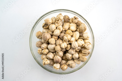 A bowl of Javanese cardamom sits on a white background