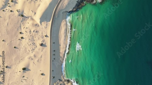 Aerial view of beautiful coastline with sandy beach and tranquil waves, Parque Natural de Corralejo, Fuerteventura, Canary Islands, Spain.