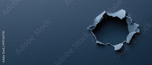 A close-up of an irregular hole in a dark blue surface, showcasing torn edges and a sense of depth.