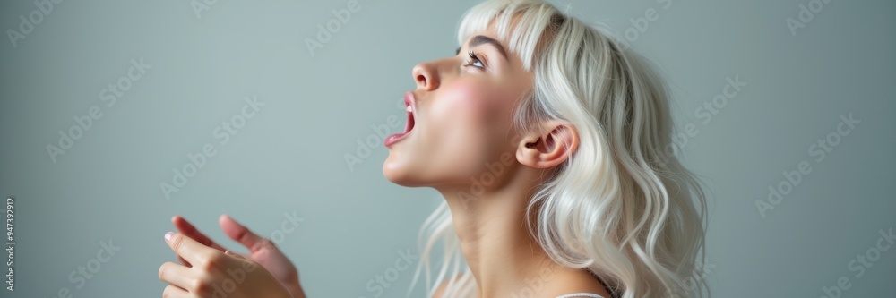 A young woman with blonde hair looks upwards, expressing emotion. This image captures introspection and contemplation, ideal for wellness, beauty, or lifestyle themes. A young woman with blonde hair looks upwards, expressing emotion. This image captures introspection and contemplation, ideal for wellness, beauty, or lifestyle themes.