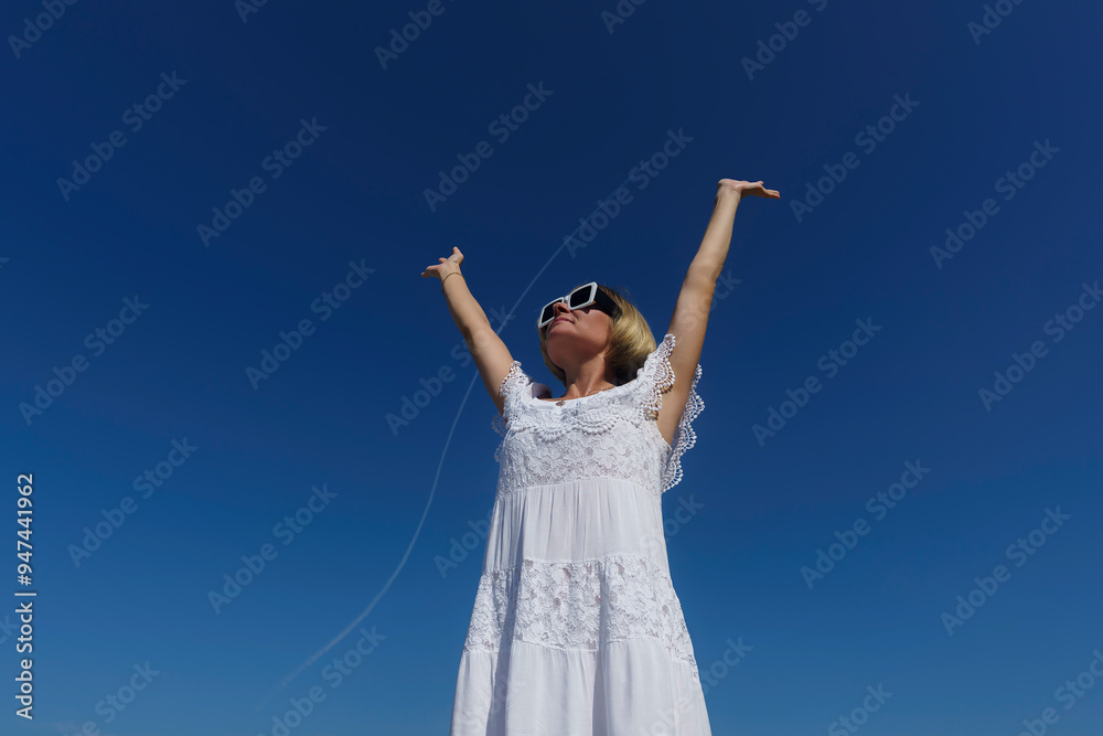 happy, confident woman rejoices by raising her hands up to the flying plane. positive, motivation happy, confident woman rejoices by raising her hands up to the flying plane. positive, motivation