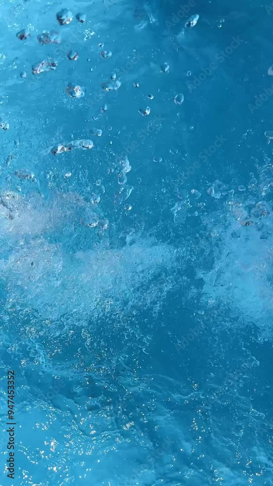 Drops falling on the water in swimming pool, vertical video Drops falling on the water in swimming pool, vertical video