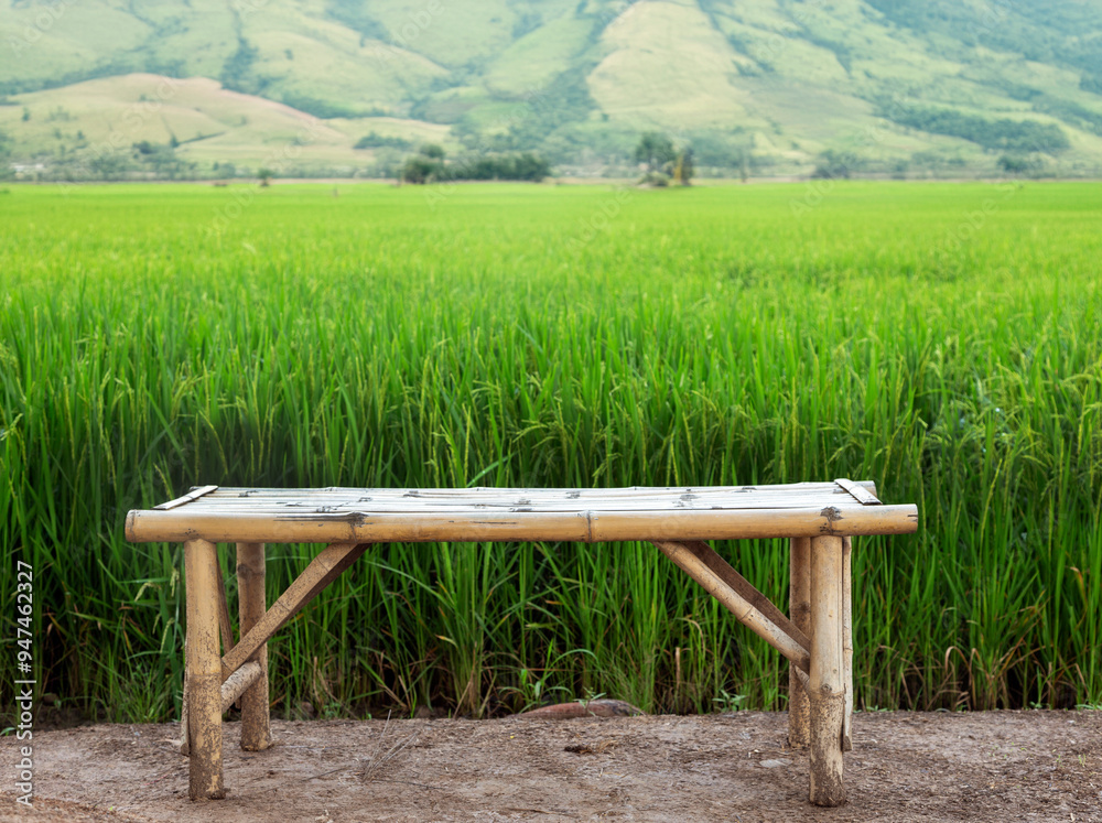 Handmade bamboo wood seat on rice field with mountain landscape Handmade bamboo wood seat on rice field with mountain landscape