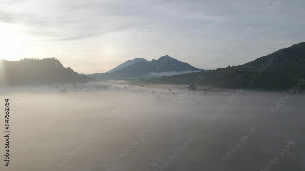 Stunning aerial view of Mount Batur at sunrise in Bali, foggy morning on Batur volcano, Indonesian nature, hiking and tourism in Bali. High quality 4k footage Stunning aerial view of Mount Batur at sunrise in Bali, foggy morning on Batur volcano, Indonesian nature, hiking and tourism in Bali. High quality 4k footage