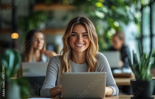 Free Download A photo of happy businesswoman in an office, using laptops and discussing work with each other.  - GFXLoad