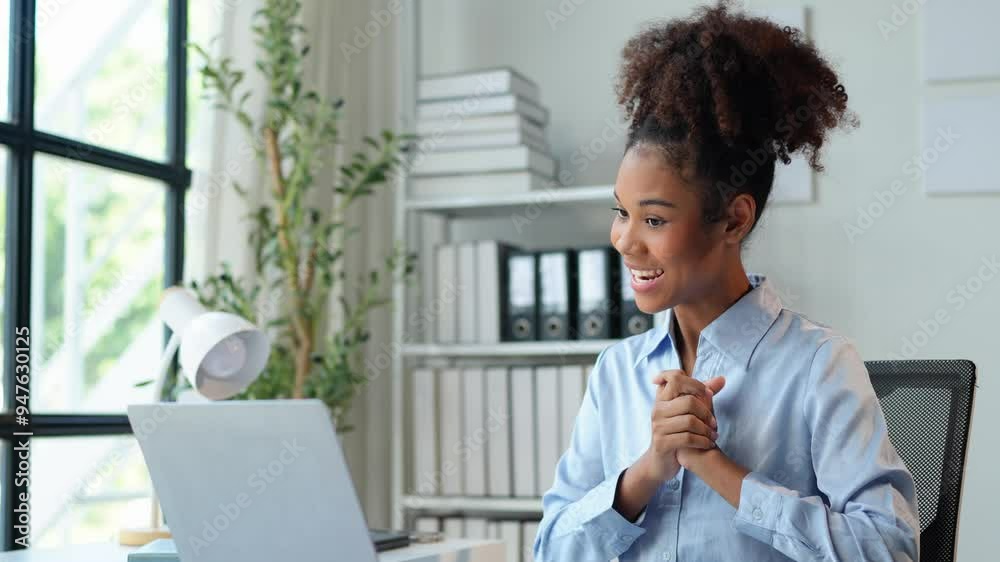 African american businesswoman sitting and recording data details in financial business Online marketing plan to process and send emails for meeting preparation sitting at laptop desk in office.
