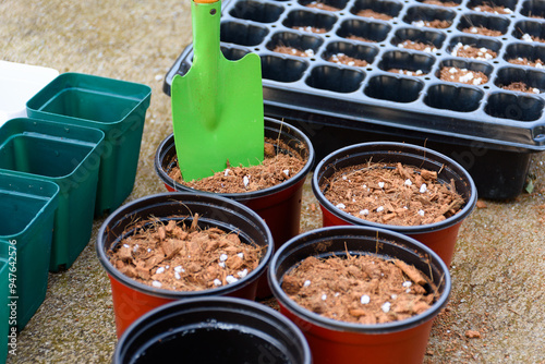 Green shovel and soil fertilizer in a pot for planting is preparing fertilizer for agricultural planting. Agricultural equipment for cultivation and nursery, peat moss, coco husk chips.