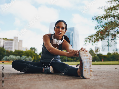 Woman, fitness and stretching legs outdoor in city for healthy body, flexible and exercise for wellness. Sports, start and runner warm up muscle to prepare for workout, training or marathon on road photo