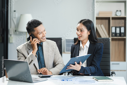 Business team working on a project in the office or reviewing and discussing a business project.