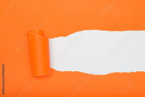 Torn orange paper revealing a white background. Space for text.