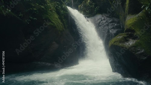 Waterfall rushing into a pool of water in a rainforest Jungle