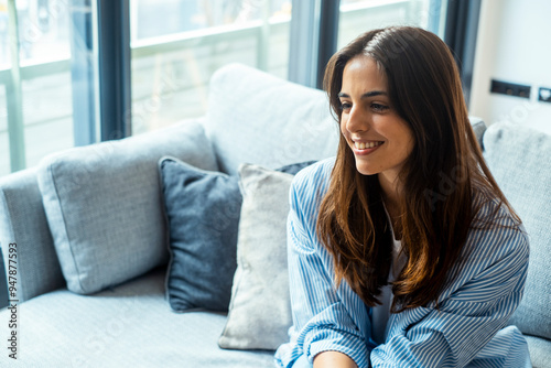 Young adult woman smiling gently on the sofa while listening to her boyfriend or husband discuss their future together. Captures the essence of awareness and patient support during a home mental Free Download Young adult woman smiling gently on the sofa while listening to her boyfriend or husband discuss their future together. Captures the essence of awareness and patient support during a home mental - GFXLoad