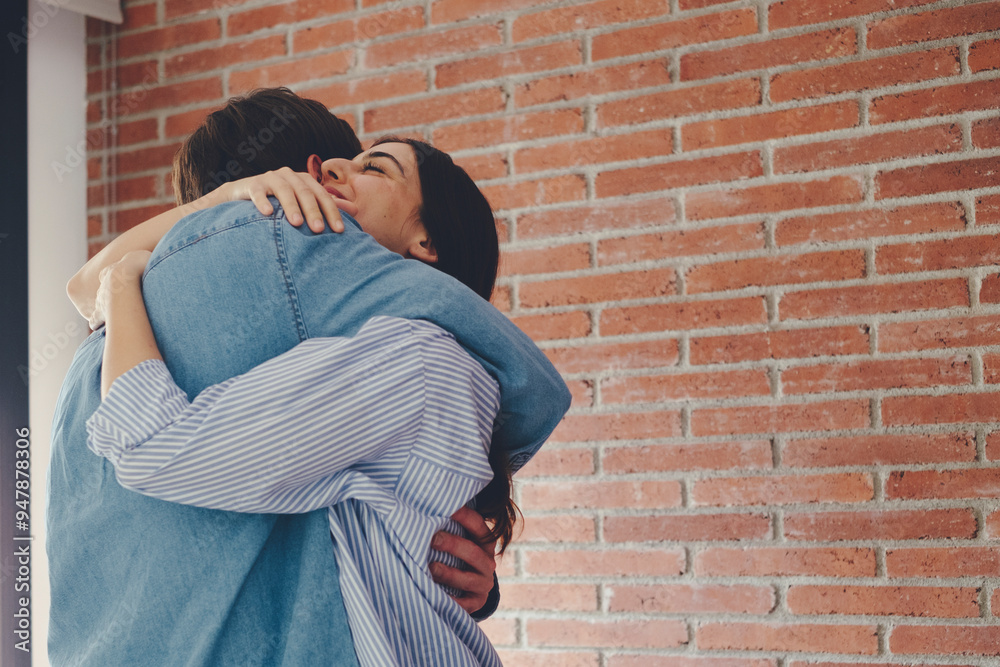 Heartwarming moment of a woman joyfully embracing her partner after he proposes. The scene captures the emotional happiness of an engagement, with two people celebrating together at home, filled Heartwarming moment of a woman joyfully embracing her partner after he proposes. The scene captures the emotional happiness of an engagement, with two people celebrating together at home, filled