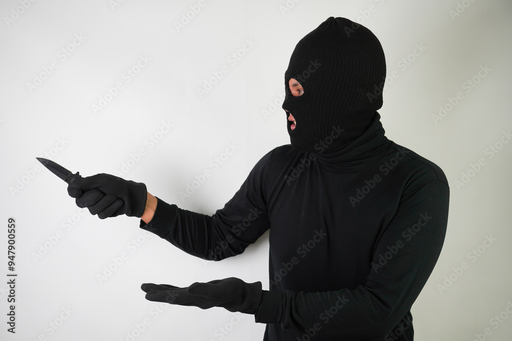 Armed and Dangerous Young Adult black masked robber brandished a knife at the victim in an attempt to steal valuable items. Armed and Dangerous Young Adult black masked robber brandished a knife at the victim in an attempt to steal valuable items.