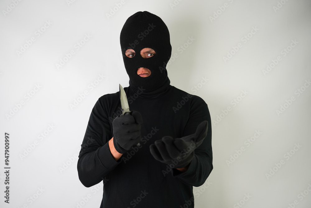 Armed and Dangerous Young Adult black masked robber brandished a knife at the victim in an attempt to steal valuable items. Armed and Dangerous Young Adult black masked robber brandished a knife at the victim in an attempt to steal valuable items.