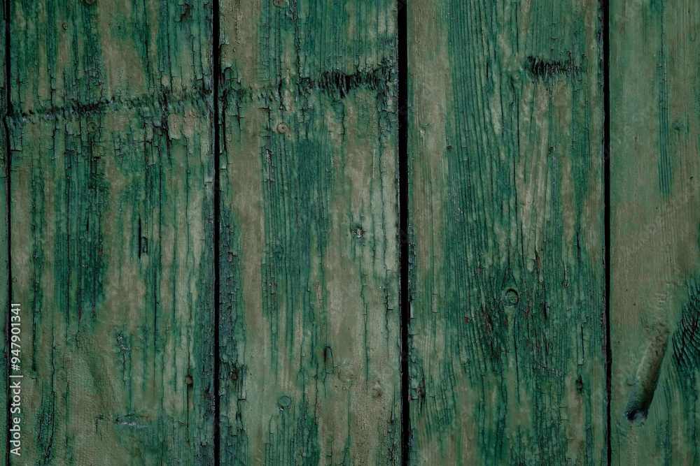 Fototapeta premium Weathered green wooden planks arranged in a vertical pattern showcasing rustic charm and texture