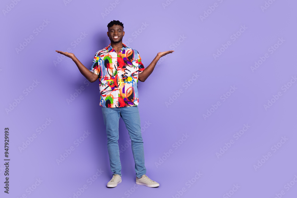 Full body portrait of nice young man hold empty space ad isolated on purple color background Full body portrait of nice young man hold empty space ad isolated on purple color background