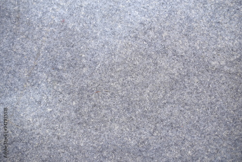 Gray felt texture background. Thick, soft textile material, made of wool, cotton or something else. Rough blanket texture.