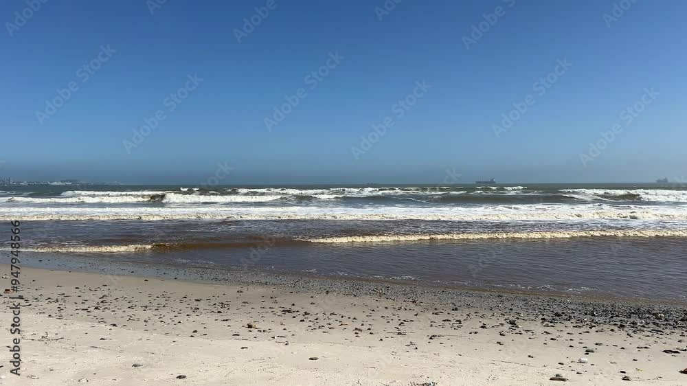 White waves rolling to the beach with ships on the horizon White waves rolling to the beach with ships on the horizon