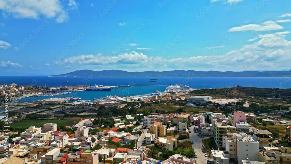 A coastal greek town with a vibrant harbor and distant mountains under a clear sky, aerial view A coastal greek town with a vibrant harbor and distant mountains under a clear sky, aerial view