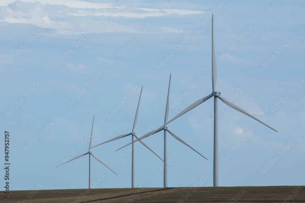 Fototapeta premium Symmetry in a row of turbines on a wind farm