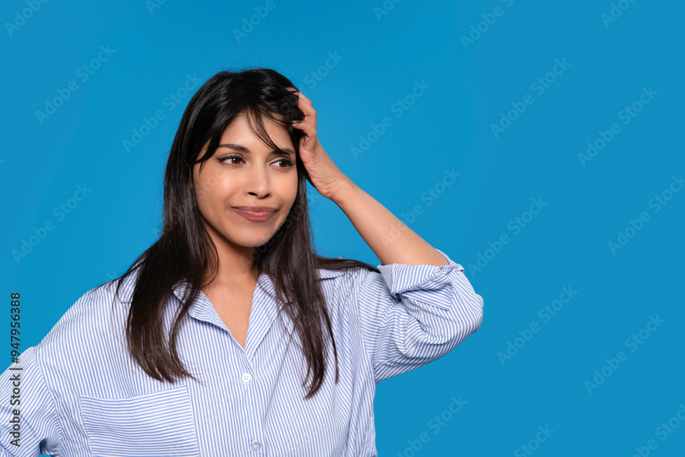 Contemplative Woman in Casual Attire Against Vibrant Blue Backdrop Expressing Thoughtful Emotions Contemplative Woman in Casual Attire Against Vibrant Blue Backdrop Expressing Thoughtful Emotions