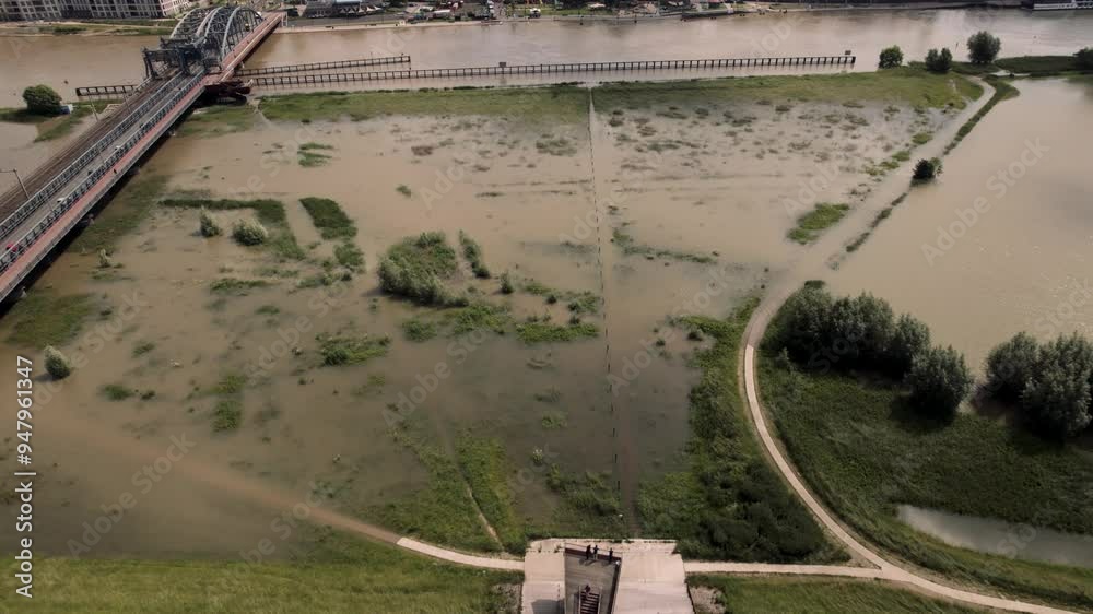 Forward aerial movement showing the quay at river IJssel with high water levels on the IJsselkade boulevard of tower town Zutphen urban development
