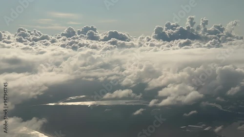 Sun is rising above the endless sea of clouds until the horizon. Fluffy clouds on blue sky as background photo