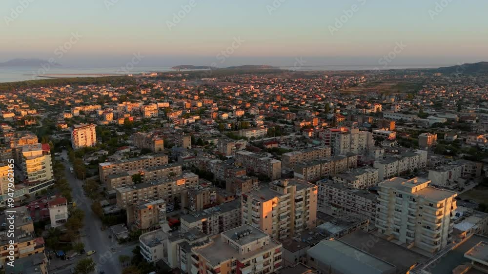 Aerial sunrise view over the city of Vlora, Albania, highlighting urban sprawl and coastline