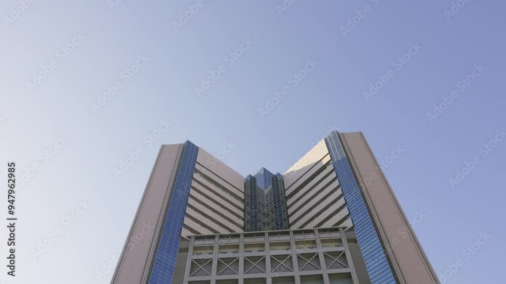 Tokyo hospital building against a clear blue sky captured from a low-angle view Tokyo hospital building against a clear blue sky captured from a low-angle view