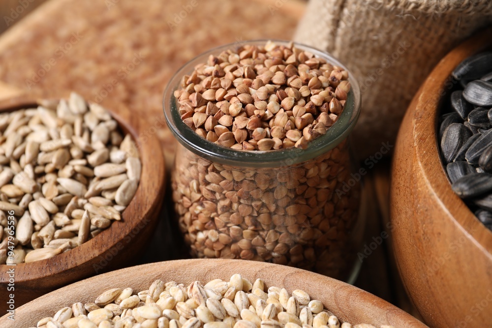 Obraz premium Different types of cereals and seeds on table, closeup