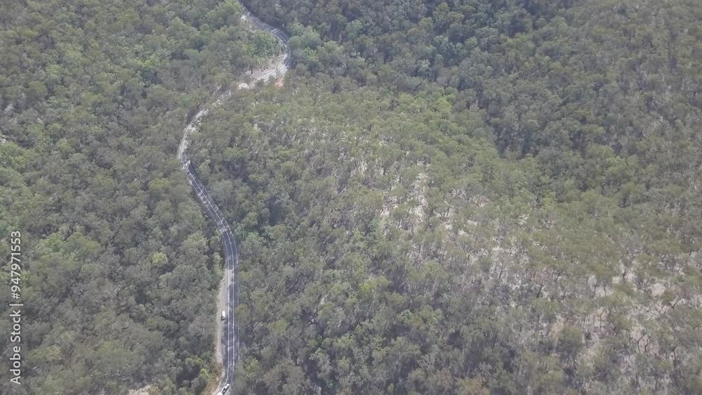 Aerial view of beautiful lush forest with a serene road, Blue Mountains National Park, New South Wales, Australia. Aerial view of beautiful lush forest with a serene road, Blue Mountains National Park, New South Wales, Australia.