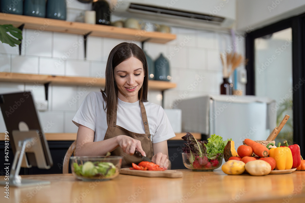 Young Woman Preparing a Healthy Salad in a Modern Kitchen with Fresh Vegetables and a Smile Young Woman Preparing a Healthy Salad in a Modern Kitchen with Fresh Vegetables and a Smile