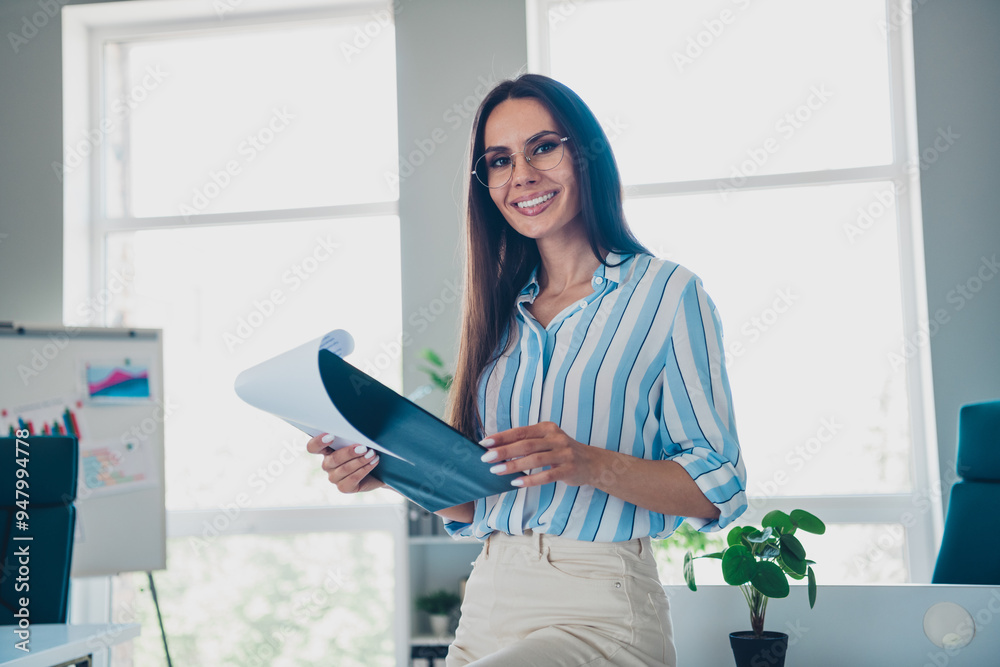 Photo of nice woman read report paperholder dressed striped formalwear comfortable light startup office room interior Photo of nice woman read report paperholder dressed striped formalwear comfortable light startup office room interior