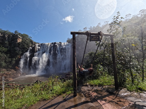 turista em balanço defronte ao salto corumbá, goiás photo