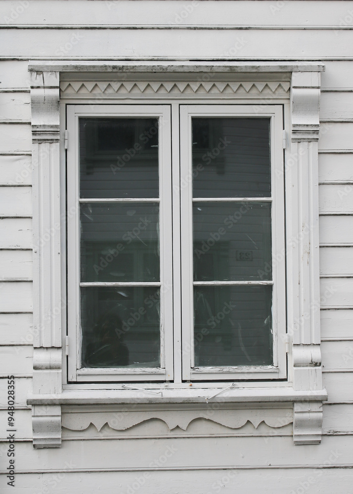 Fototapeta premium Beautiful old window of a white timber house in Stavanger, Norway.