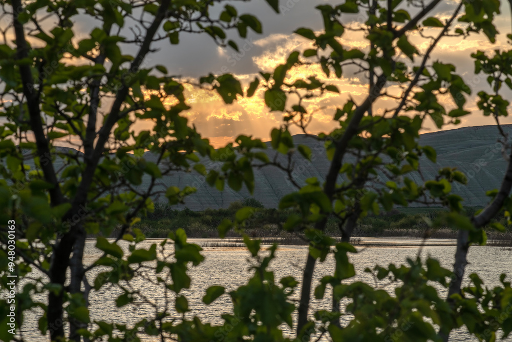 Fototapeta premium Sunset view by the lake in the evening. Sunset over the lake in the evening. Sunset from the campsite in the evening.