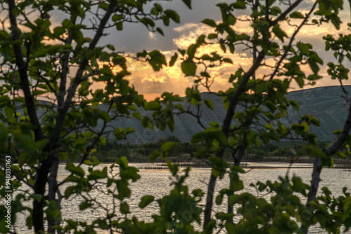 Sunset view by the lake in the evening. Sunset over the lake in the evening. Sunset from the campsite in the evening.