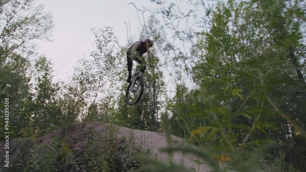 Dirt jumper landing from air on ramp and conquering hill Dirt jumper landing from air on ramp and conquering hill
