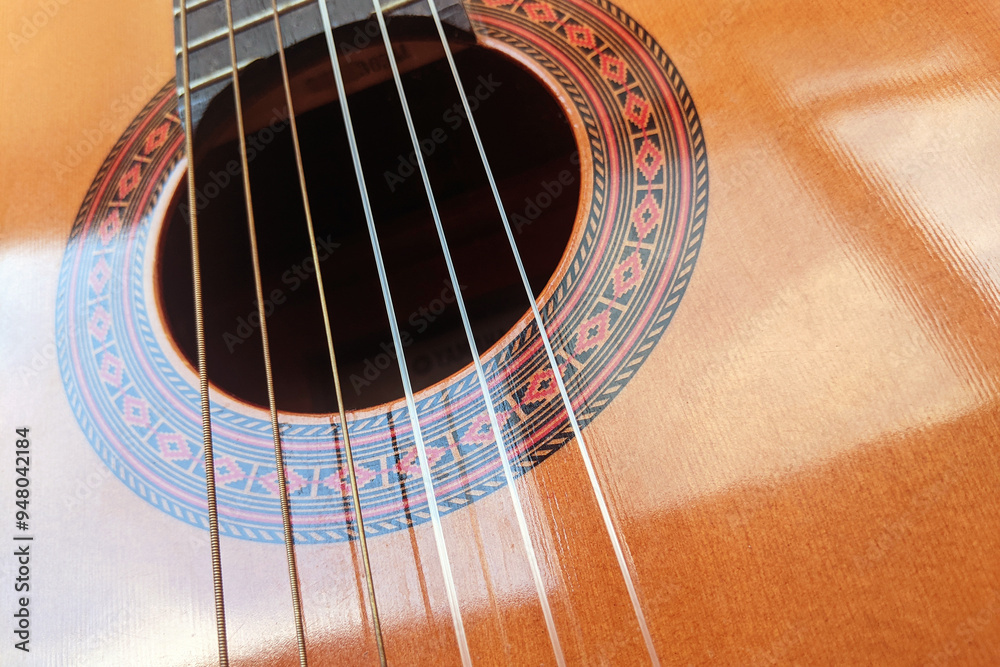 Echo of strings: a close-up of the guitar resonator and strings — melody in the details. Echo of strings: a close-up of the guitar resonator and strings — melody in the details.