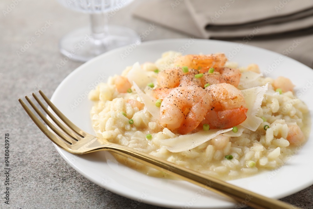 Delicious risotto with shrimps and cheese on grey table, closeup Delicious risotto with shrimps and cheese on grey table, closeup