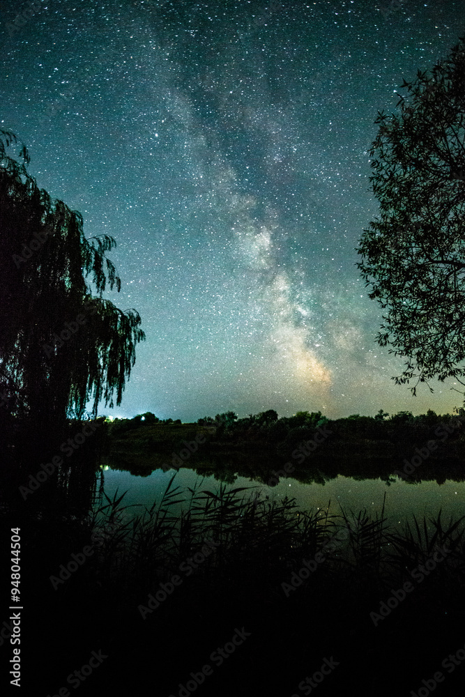 Fototapeta premium Night on the lake with beautiful night sky . Milky Way over the lake . Sky with stars , landscape in the night 