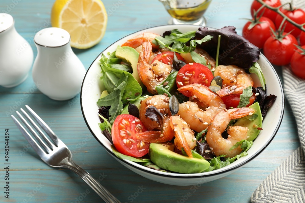 Delicious shrimp salad and ingredients on light blue wooden table, closeup Delicious shrimp salad and ingredients on light blue wooden table, closeup