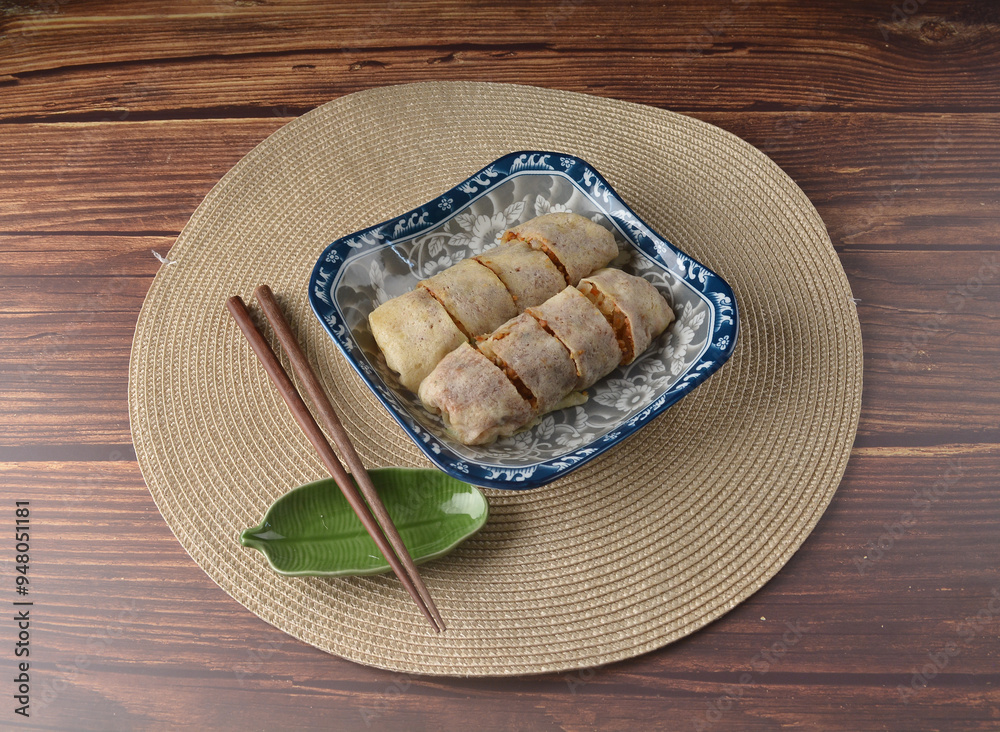 Homemade traditional asian food nyonya Popiah Spring Roll fresh vegetables, bean curd, fried shallots, dried shrimp, sweet chili paste and braised turnip on wood table vegan halal menu for cafe