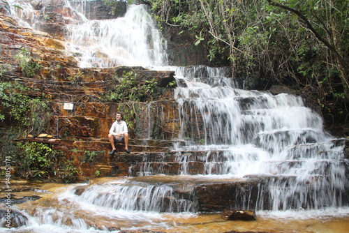 homem na cachoeira dos dragões, em pirenópolis, goiás photo