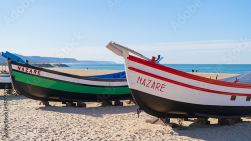 colorful fishing boats made of wood on the beach fishing village Nazare. photo
